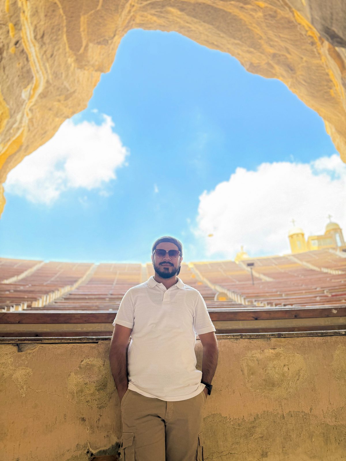 Faiq inside the Cave Church amphitheater carved into the Mokattam cliffs in Cairo