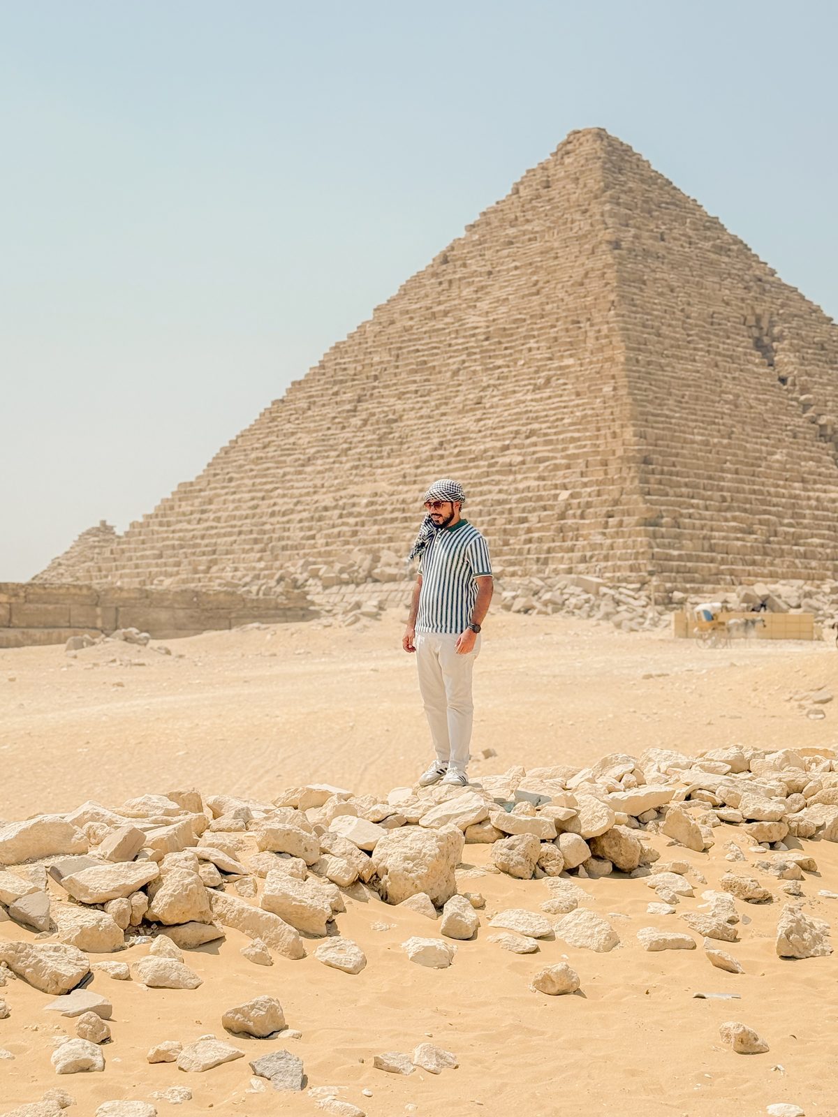 Faiq standing before a pyramid at Giza