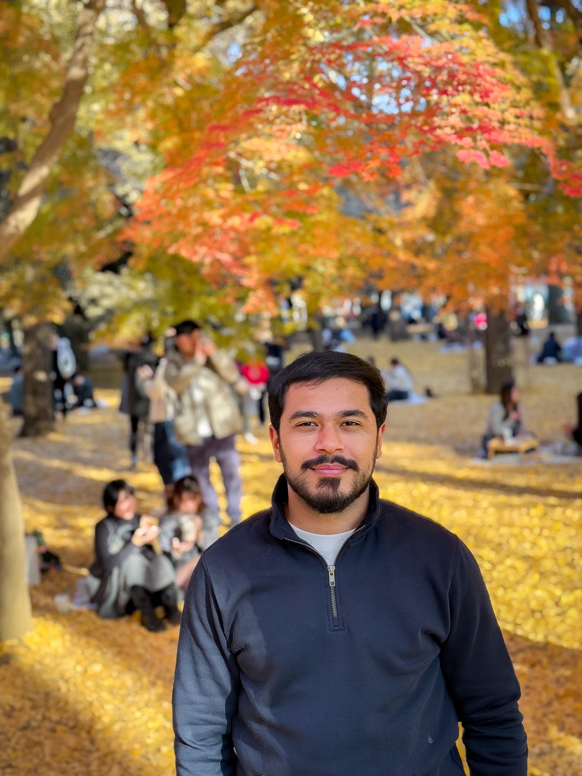 Faiq in a Tokyo park carpeted with golden ginkgo leaves
