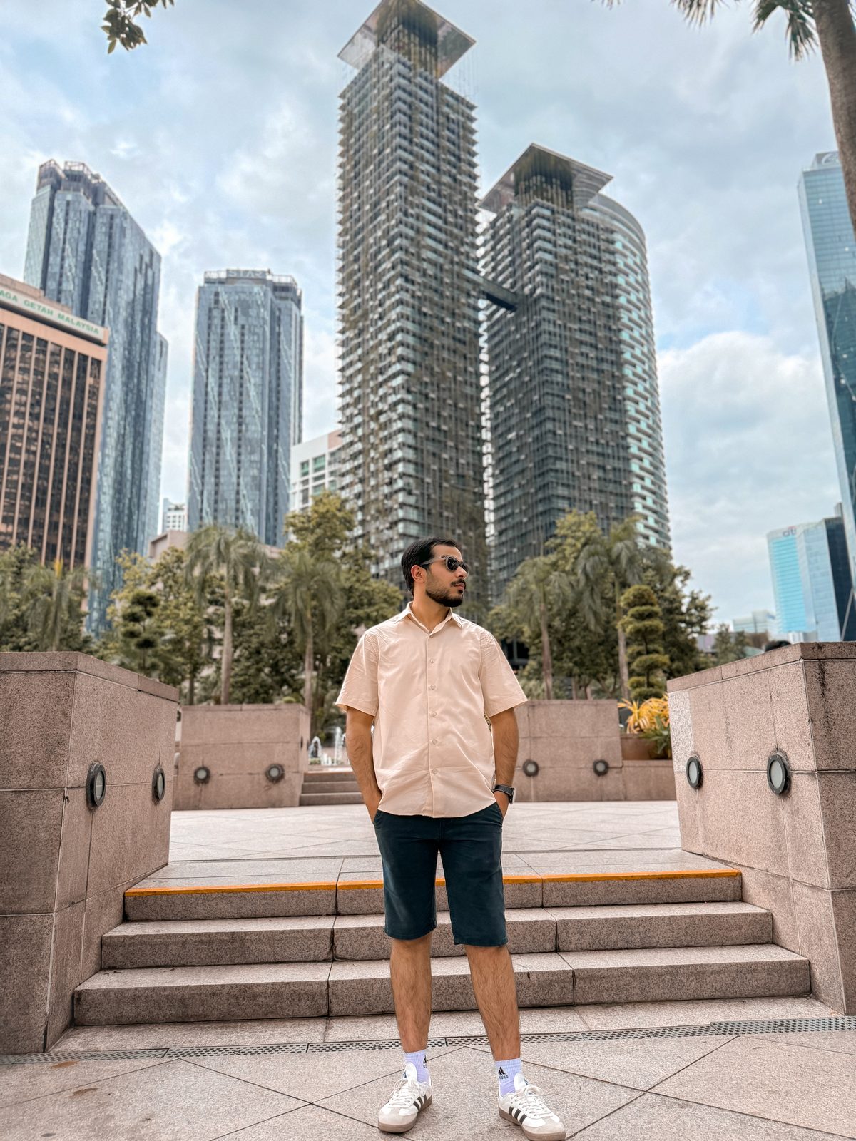 Faiq at KLCC plaza surrounded by Kuala Lumpur skyscrapers